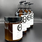 Faire Taire body and hair care set on a black background, featuring body moisturizer, body oil, shampoo, and conditioner.