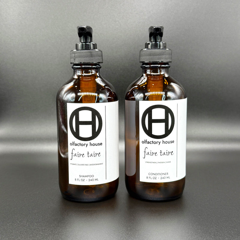 Faire Taire hair care duo on a black background, with shampoo and conditioner bottles side by side.