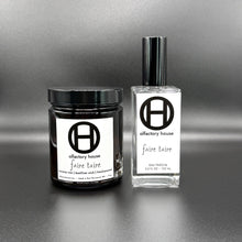 Faire Taire home and body fragrance set on a black background, including a large candle and eau fraîche bottle.