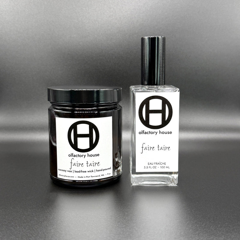 Faire Taire home and body fragrance set on a black background, including a large candle and eau fraîche bottle.