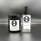 Sweet Ginger home and body fragrance set on a black background, with large candle and eau fraîche bottle.