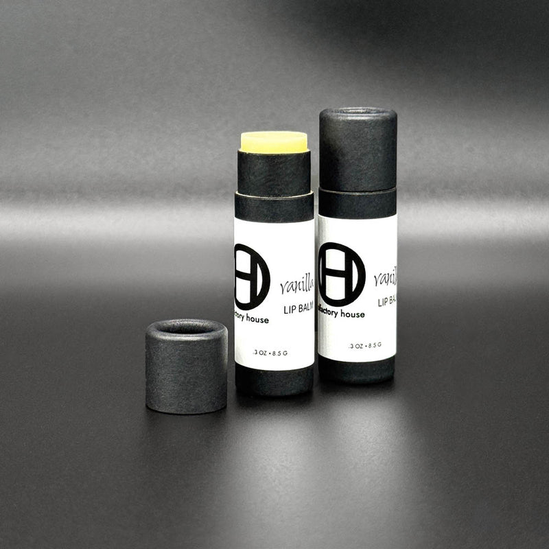 Olfactory House Vanilla lip balm comes in a cardboard tube with a  pull off lid. The balm is dispensed by pushed up on the bottom of the packaging. 